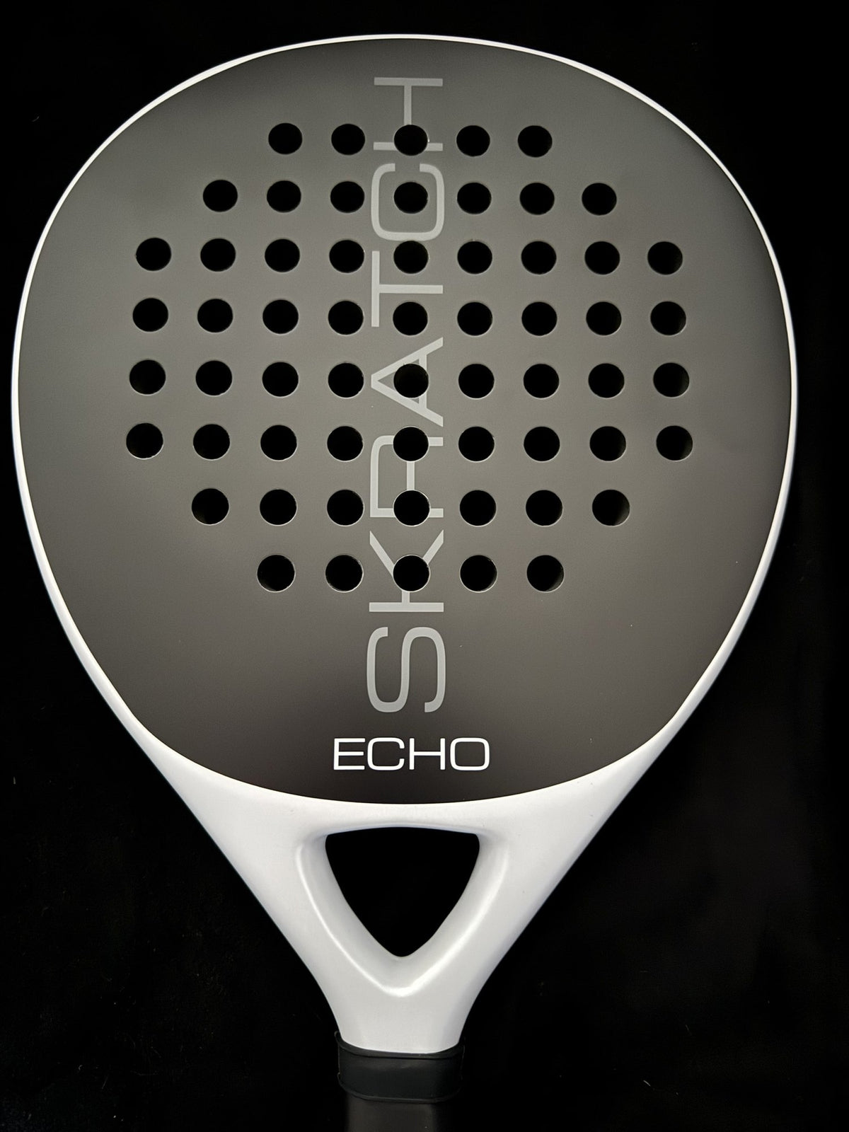 Close up studio shot of the SKRATCH ECHO padel racket with a matte black carbon face and mist grey pearlescent frame.