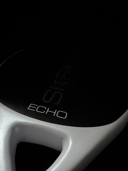 Close up studio shot of the SKRATCH ECHO padel racket showing the mist grey pearlescent bridge detail and ECHO model name.